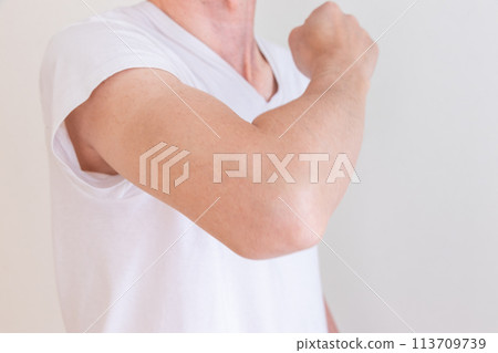 Man raising his arm with elbow bent 113709739
