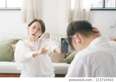 Couple arguing in the living room Couple arguing in the living room 113710483