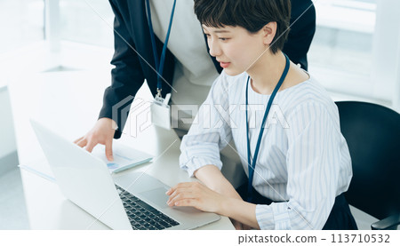 Young men and women operating computers in the office Young men and women operating computers in the office 113710532