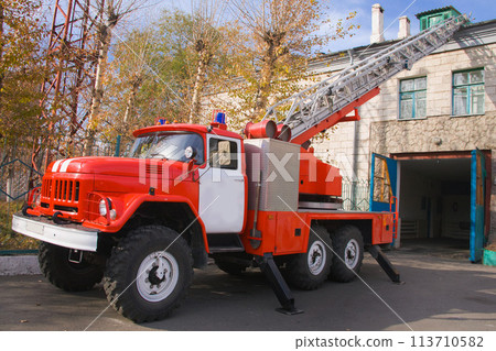 A large soviet red fire truck ZIL is preparing to leave. A large soviet red fire truck ZIL is preparing to leave. 113710582