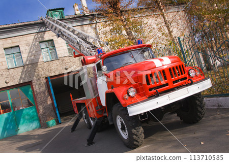 A large soviet red fire truck ZIL is preparing to leave. 113710585