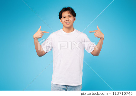 Casual young guy pointing at himself, blue background 113710745