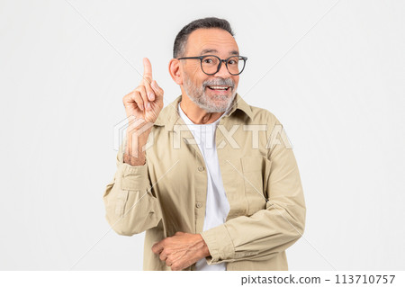 Senior man with index finger raised in a eureka moment Senior man with index finger raised in a eureka moment 113710757