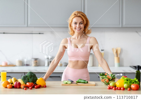 Fitness enthusiast with veggies in kitchen 113710817
