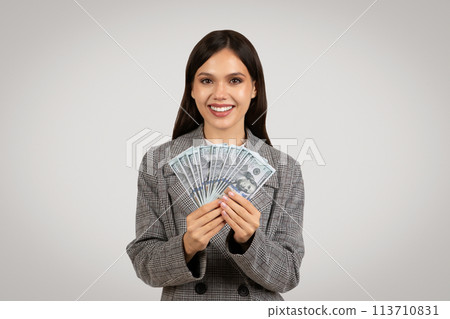 Happy young businesswoman displaying dollar cash Happy young businesswoman displaying dollar cash 113710831