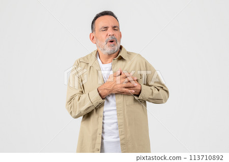 Senior man experiencing chest pain on background Senior man experiencing chest pain on background 113710892