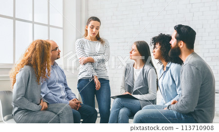 Sad addicted woman sharing her problems at rehab group meeting Sad addicted woman sharing her problems at rehab group meeting 113710908