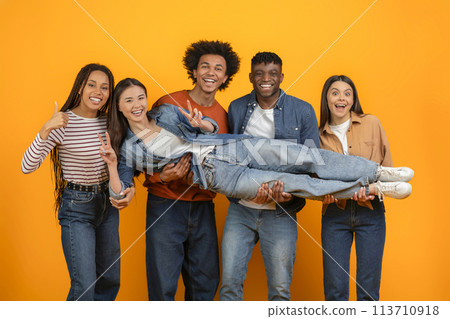 Friends carrying a lady in their arms 113710918