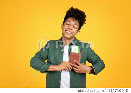 Content african american guy clutching passport and dreaming Content african american guy clutching passport and dreaming 113710948