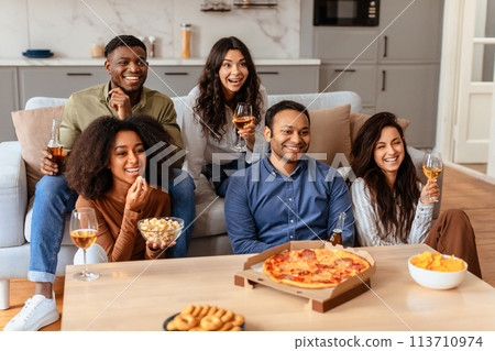 Group of friends enjoying a meal and wine together 113710974