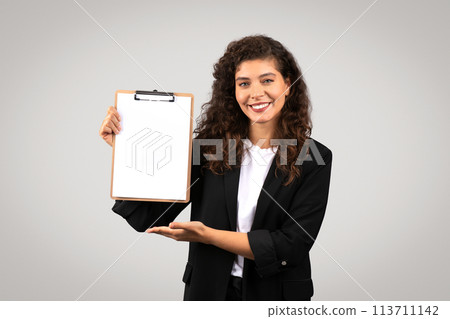 Woman presenting a blank clipboard to viewer 113711142
