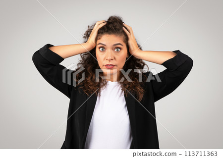 Stressed young woman holding her head 113711363