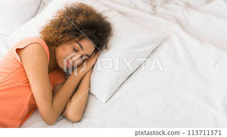 African-american woman sleeping in her bed at home African-american woman sleeping in her bed at home 113711371