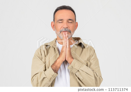Senior man in prayer gesture isolated on white 113711374
