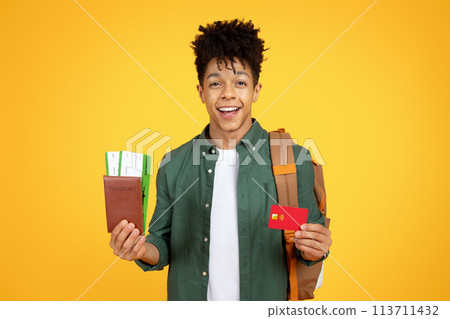 Confident african american guy traveler with backpack and travel items Confident african american guy traveler with backpack and travel items 113711432