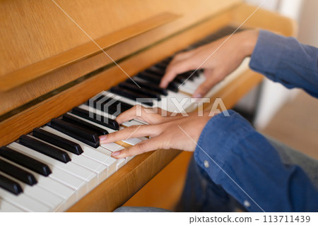 Practicing piano, focused on the keys Practicing piano, focused on the keys 113711439
