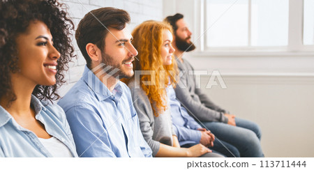Multiethnic millennial people sitting in row and looking at speaker 113711444