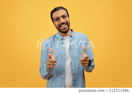 Man with direct camera gaze giving thumbs up 113711496