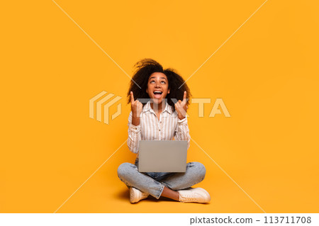 Excited woman with laptop sitting on floor Excited woman with laptop sitting on floor 113711708