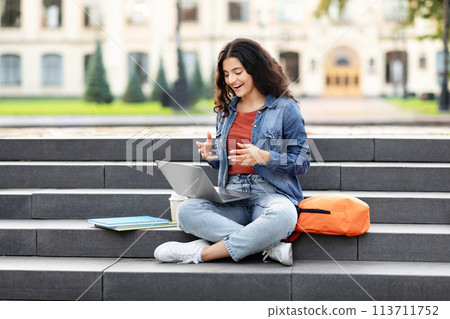 Content lady using laptop on campus stairs Content lady using laptop on campus stairs 113711752