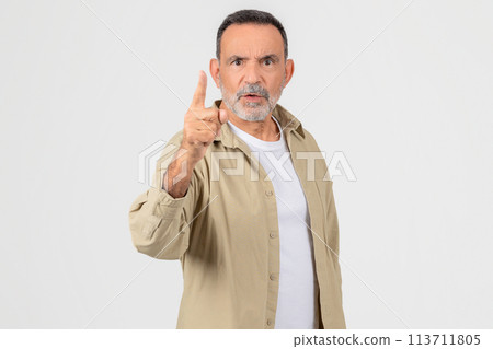 Senior man scolding with finger up on white background 113711805