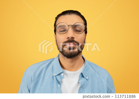 Man with eyes closed in a peaceful expression Man with eyes closed in a peaceful expression 113711886