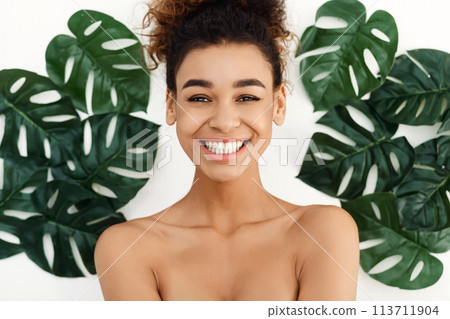 Portrait of beautiful woman in tropical leaves Portrait of beautiful woman in tropical leaves 113711904