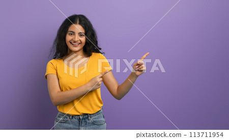 Woman in yellow pointing in two directions 113711954