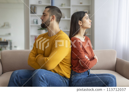 Couple sitting back-to-back looking upset 113712037