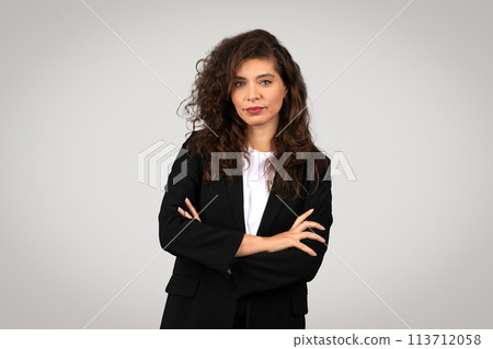 Confident businesswoman with arms crossed 113712058