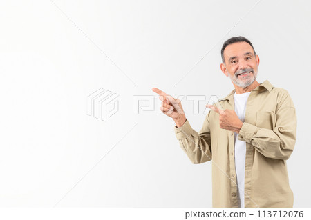 Senior man pointing to his side with a smile 113712076