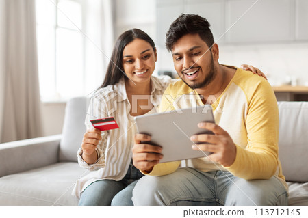Indian couple shopping online with tablet at home 113712145