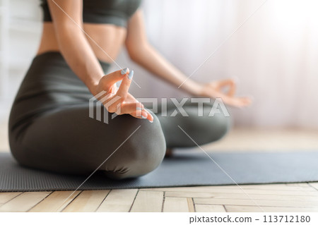 Closeup shot of woman's hands performing yoga mudra gesture 113712180