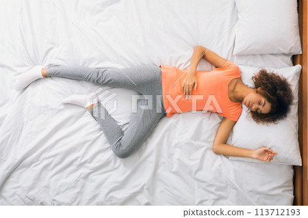 Delighted african-american woman having pleasant dream in bed Delighted african-american woman having pleasant dream in bed 113712193