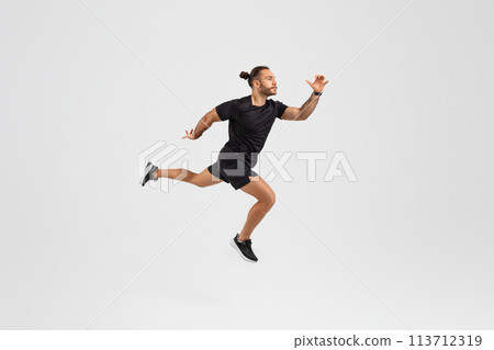 Man running in mid-air on white background 113712319
