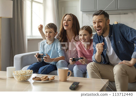 Family enjoying gaming time with laughter at home 113712440