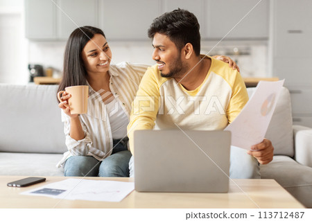 Millennial Indian couple discussing finances at home 113712487