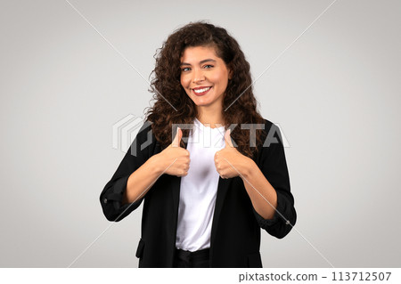 Cheerful woman giving thumbs up 113712507