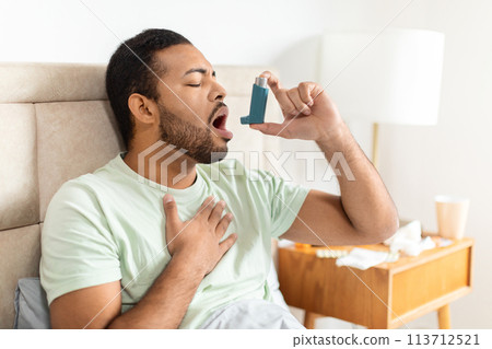 Man using inhaler during asthma attack Man using inhaler during asthma attack 113712521