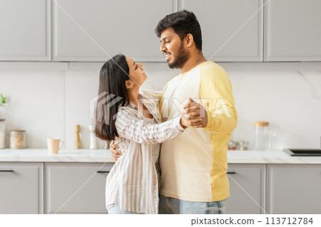 Embracing Indian spouses in a kitchen setting 113712784