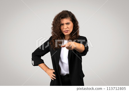 Woman pointing finger with skeptical look 113712805