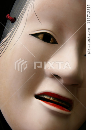 A Noh mask with gold paint on the eyes and teeth, trying to suppress jealousy. 113712815