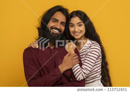 Intimate portrait of joyful couple on yellow 113712951