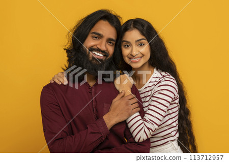 Intimate portrait of joyful couple on yellow Intimate portrait of joyful couple on yellow 113712957