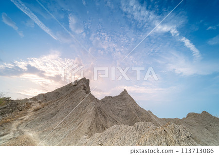 At dusk, the bare hills are set against the colorful blue sky. At dusk, the bare hills are set against the colorful blue sky. 113713086