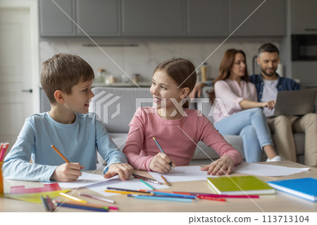 Children doing homework together, parents on background 113713104