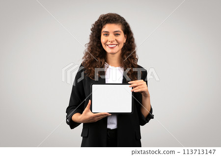 Young lady presenting a tablet with a blank screen 113713147