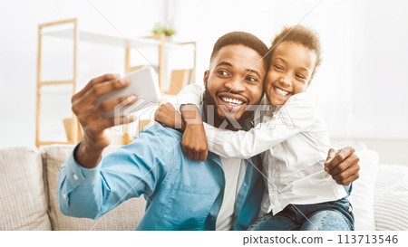 Young father with little daughter taking selfie Young father with little daughter taking selfie 113713546