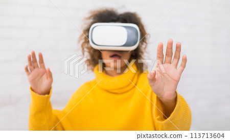 African-american woman with VR headset glasses at home African-american woman with VR headset glasses at home 113713604