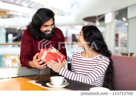 Happy romantic young eastern couple celebrating special occasion together 113713700